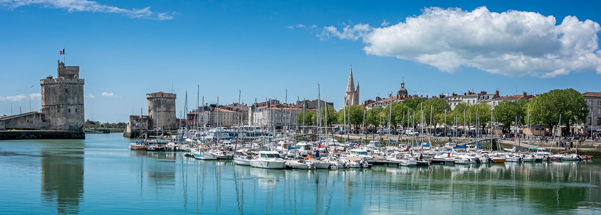 the old harbor of la rochelle, france lined with sailboats