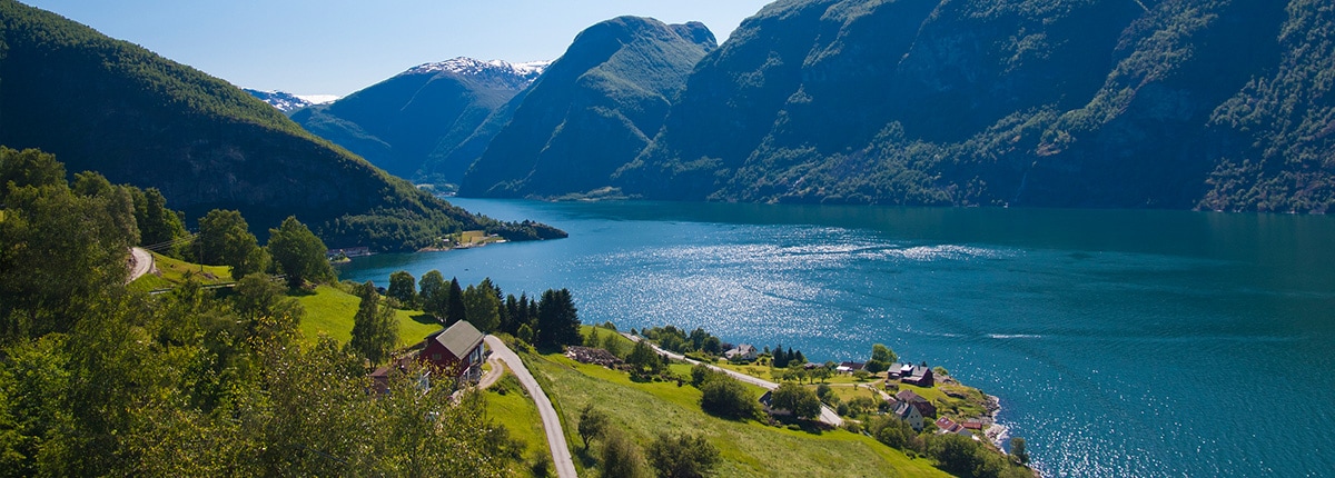 vibrant green valley and large mountains of aurland, norway