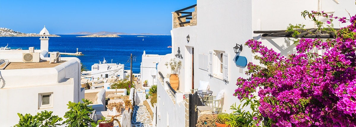 view of white houses with flowers in beautiful mykonos, greece