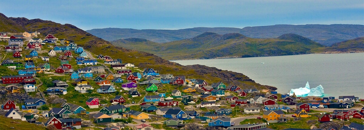 the town of qaqortoq nestled among the mountains