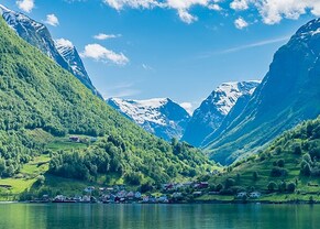 view of the town and green mountains from sognefjord