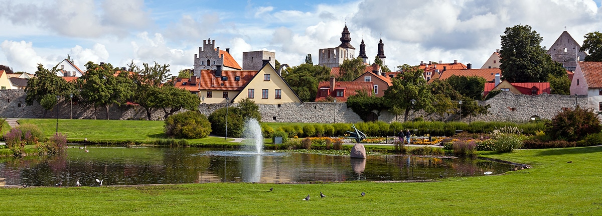a beautiful park and medieval buildings in visby