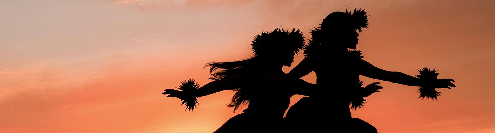 Outline of native Hawaiian women having a luau in the sunset