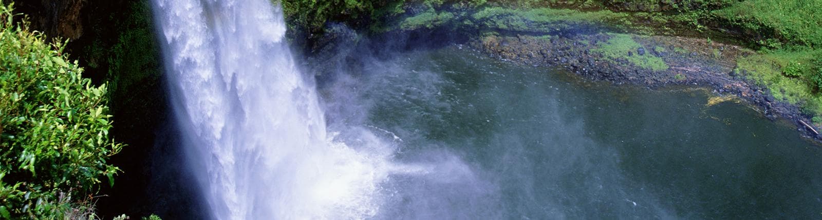 A waterfall flowing in the Wailua River in Kauai, Hawaii