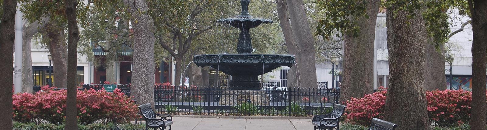 Beautiful and tranquil view of a large black fountain found in Bienville Square in Mobile, AL
