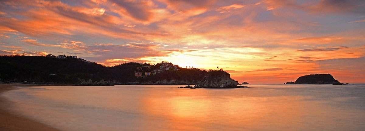 sunset on a beautiful beach in huatulco mexico