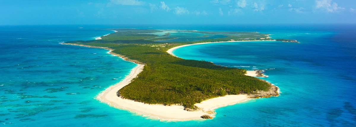 aerial view of half moon cay island shows beautiul blue water surrounding the island