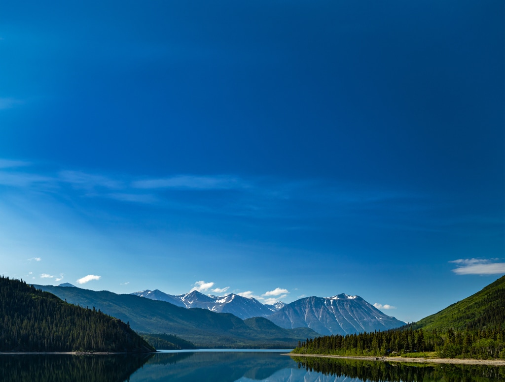 panoramic view of the snowcapped mountains and the beautiful lake in alaska