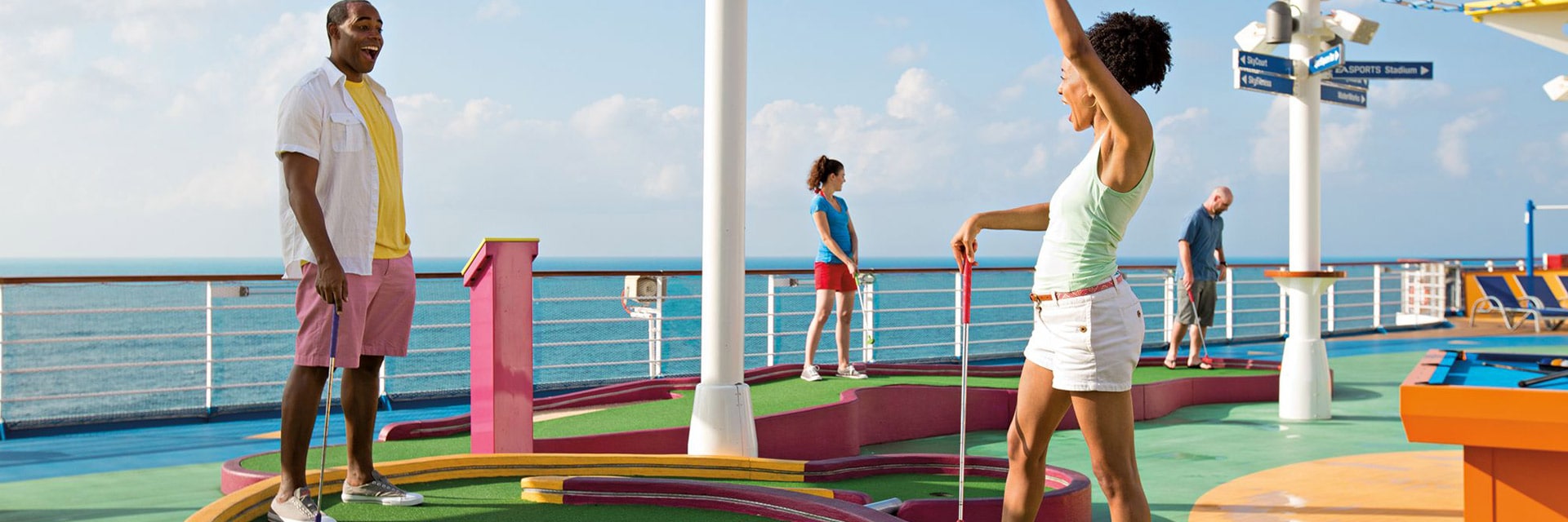 Guests enjoying a fun game of mini golf onboard their carnival cruise