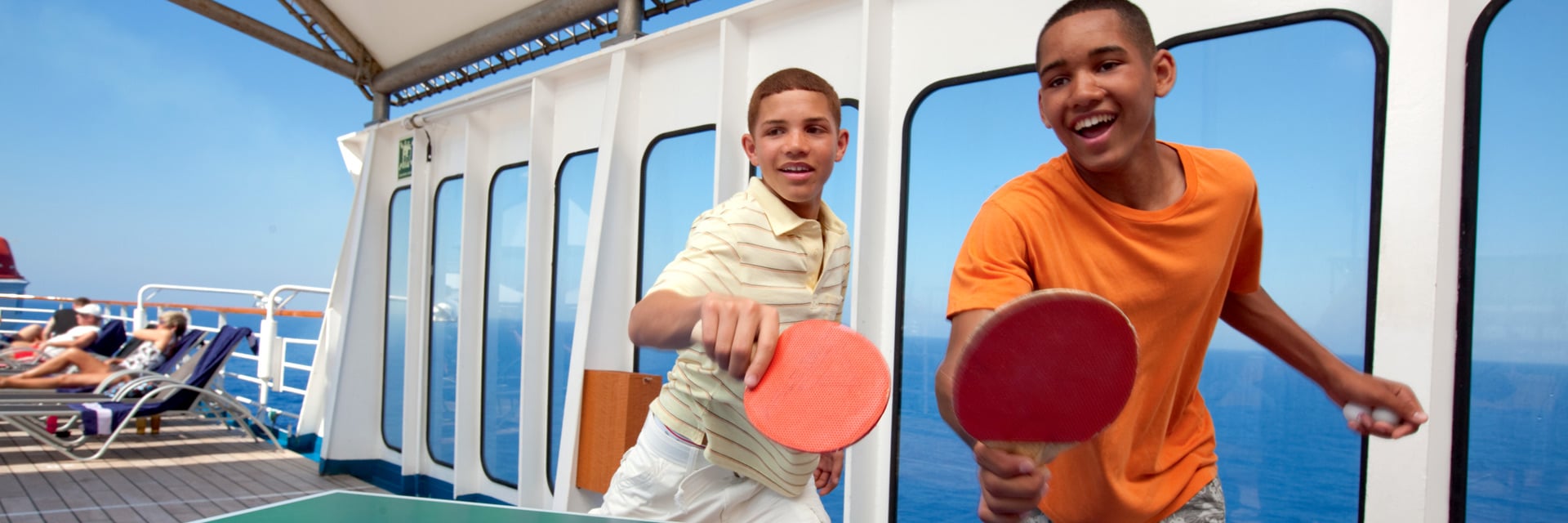 guests playing a fun game of ping pong onboard a carnival cruise