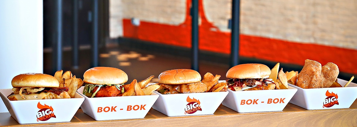 sandwiches, chicken and fries are placed in five big chicken boxes