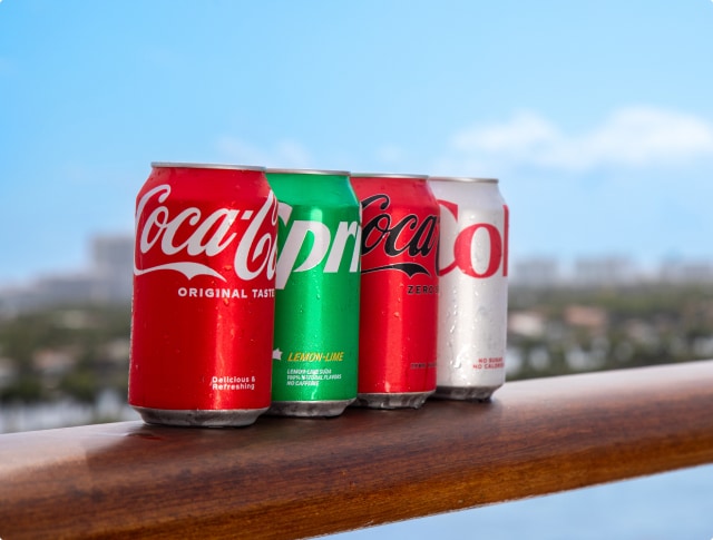 different types of coca cola products on the rail