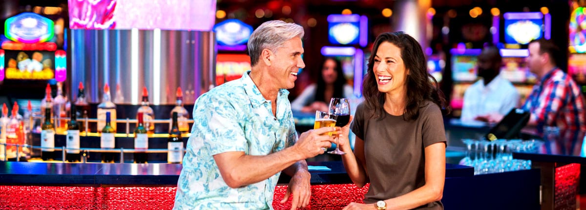 man and woman enjoying a drink at the carnival casino bar