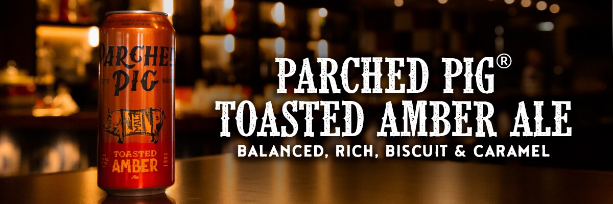 parched pig toasted amber ale with parched pig toasted amber ale logo and words balanced, rich, biscuit and caramel