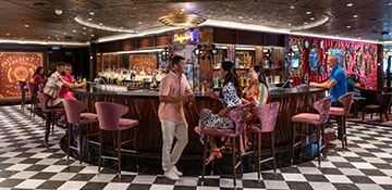 guests enjoying drinks at the fortune teller bar on a carnival cruise ship