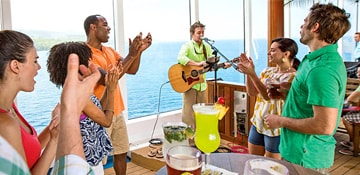 guests enjoying live music and drinks at the red frog rum bar on carnival cruise lines