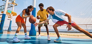 three people playing with a basketball