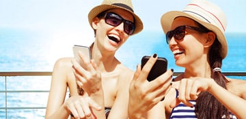 two women browsing the web on their mobile devices