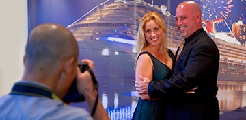 a couple smiles and embraces each other while taking a photo