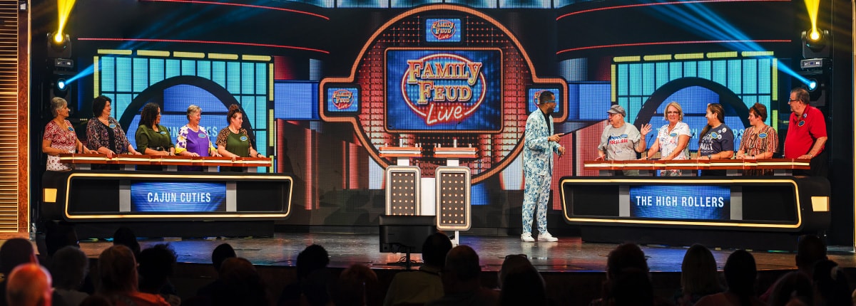 two teams and host play family feud live on stage in front of audience