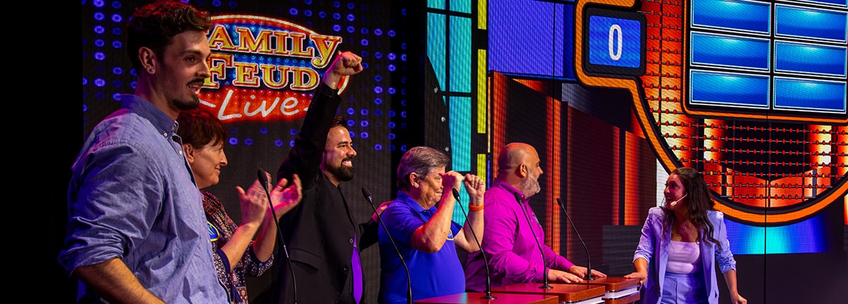 team cheers while playing family feud live