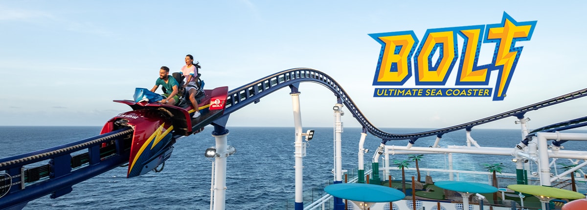 man and woman ride bolt roller coaster above ship deck and with the ocean as their backdrop