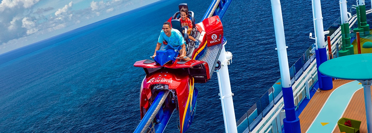 man and boy laugh while riding the bolt roller coaster aboard a carnival cruise ship