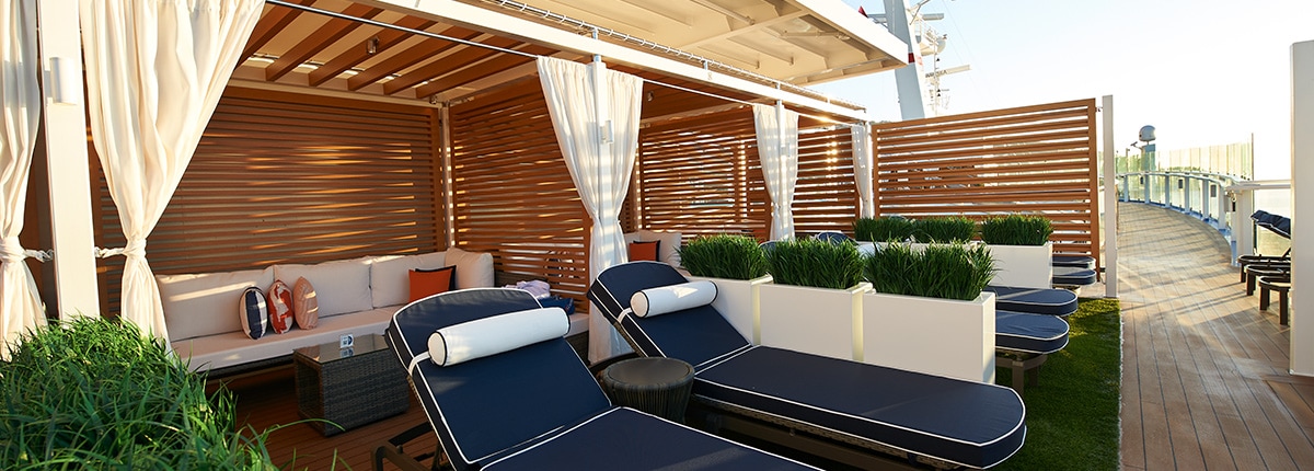 view of the loft 19 lounge chairs and seating area onboard carnival celebration