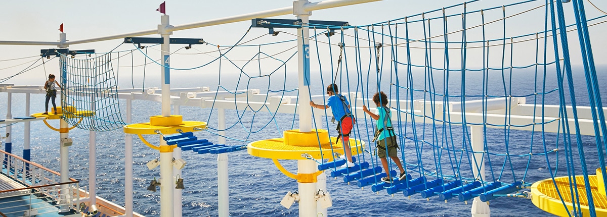 kids walking the ropes course overlooking the ocean