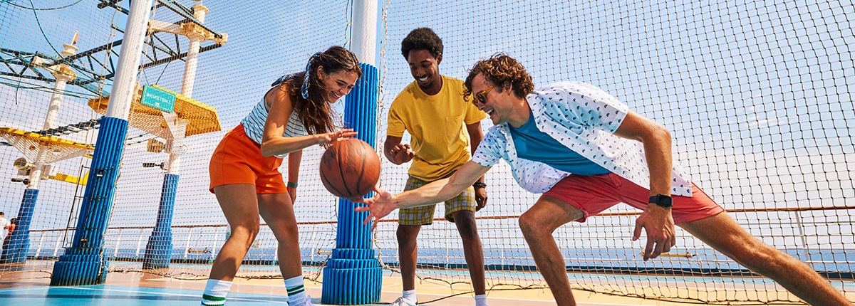 three people playing with a basketball