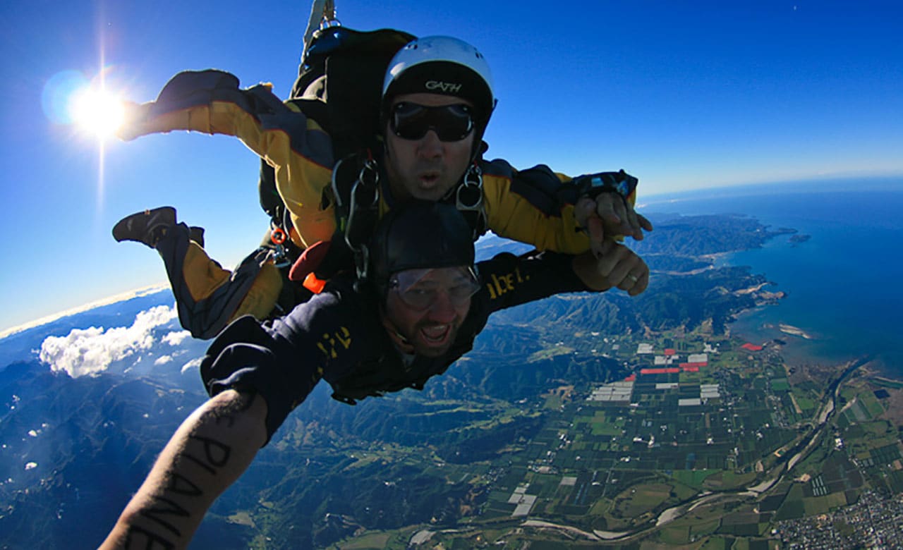Two men skydiving, attached to one another