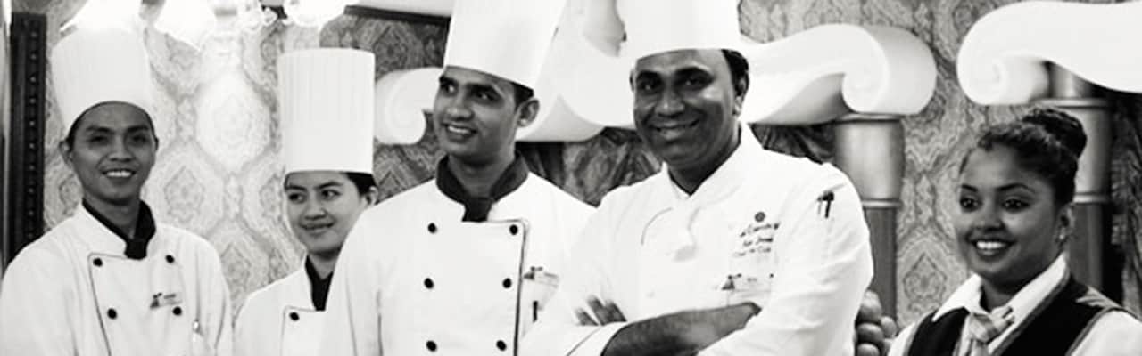 A group of five chefs and restaurant staff