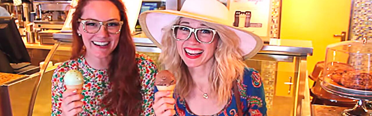 Two women smile as they each hold an ice cream cone