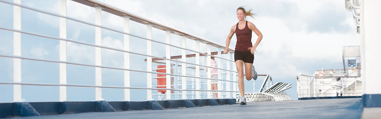 Woman running in athletic wear on ship deck