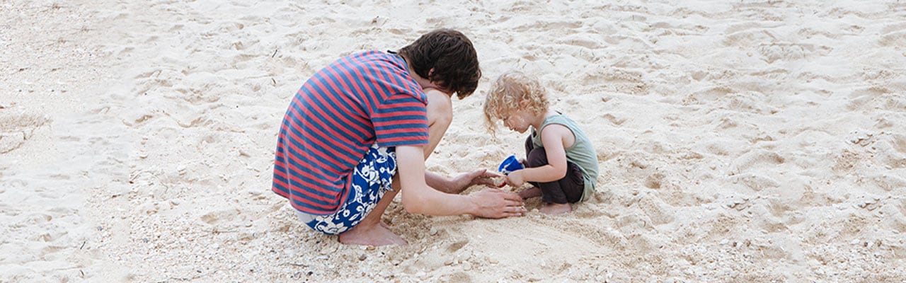 Two boys playing in sand in Jamaica