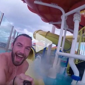 Man in Carnival Waterworks taking a selfie smiling, link to Youtube video