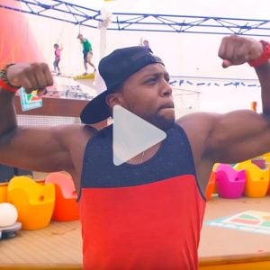 Man poses, flexing his arm muscles on a Carnival ship, link to Youtube video