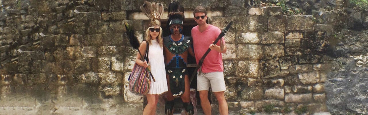 couple posing with mayan local in Cozumel Mexico