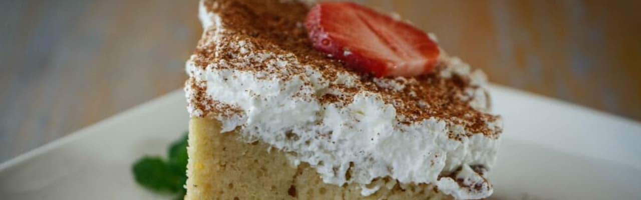 Banner with image of tres leches cake topped with a slice of strawberry