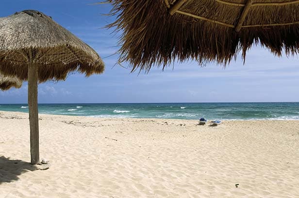 tiki beach umbrellas in cozumel, mexico