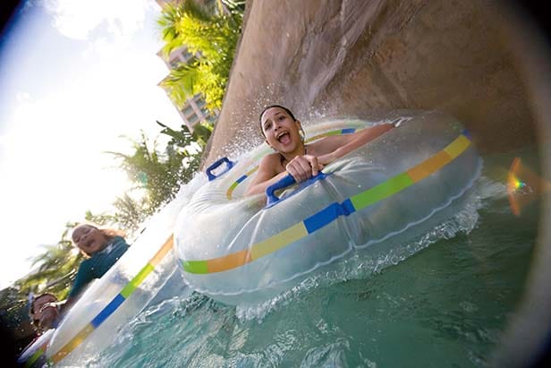 a girl having a thrilling ride on a water tube