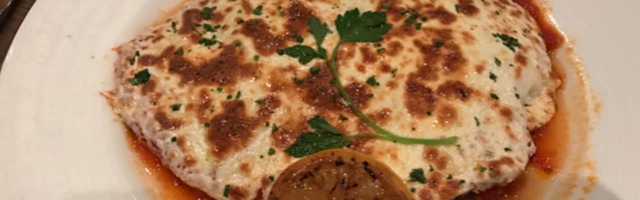 Close up of chicken Parmesan on a white plate