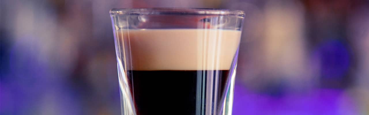 Shot glass with dark liquor