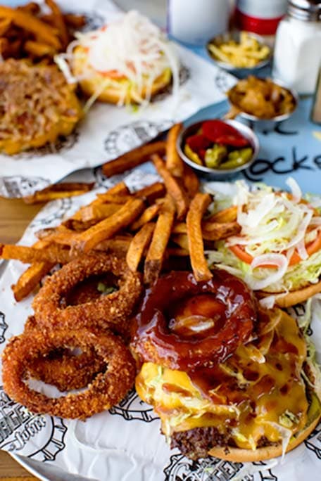 Burger with onion rings and fries