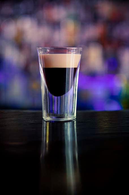 Shot glass with Kahlua coffee liqueur flavor. With Irish cream on top.