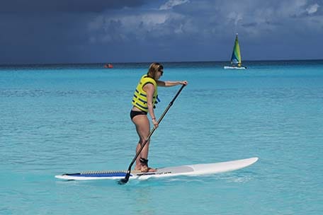 Sarah paddle boarding in Half Moon Cay