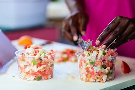 local Bahamian preparing Conch Salad, a popular dish on the island