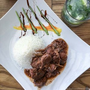 Oregano–seasoned goat stew served with white rice