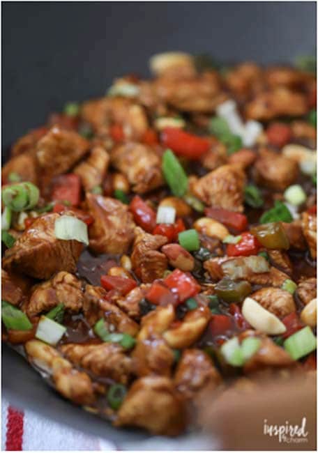 Kung Pao Chicken being cooked in a large skillet 