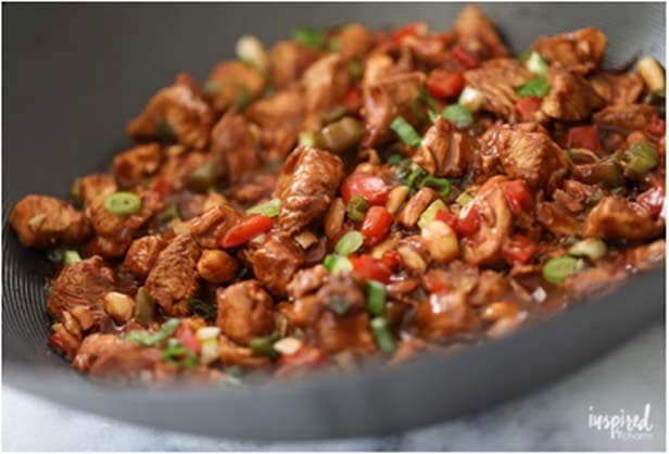 Side angle of Kung Pao Chicken cooking in large skillet
